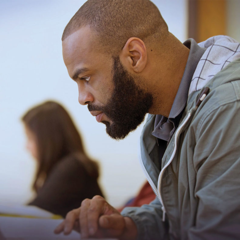 埃尔姆赫斯特大学的一名黑人beplay体育飞翔下载男研究生在做作业时趴在笔记本电脑上。